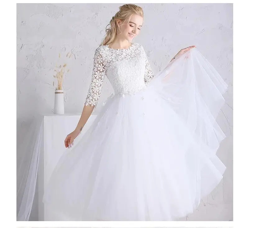 white lace floral wedding dress for party ladies small with intricate lace detailing on the bodice and ladies small sleeves featuring a voluminous tulle skirt