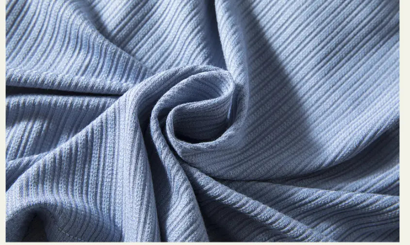 Light blue ribbed knit fabric with a soft textured surface on a women’s summerdale loose-fitting padded chest top.