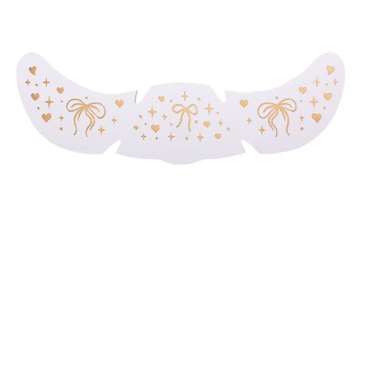 white facial mask with gold foil designs of bows hearts and stars featuring hot silver silver stamping freckle tattoo stickers