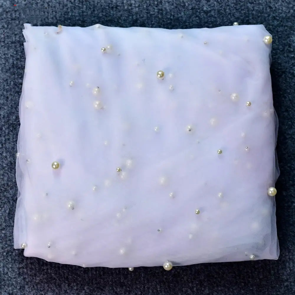 luxury heavy industry bridal pearl veil featuring delicate lavender sheer fabric adorned with scattered pearl-like beads in varying sizes and metallic accents, paired with a tiara