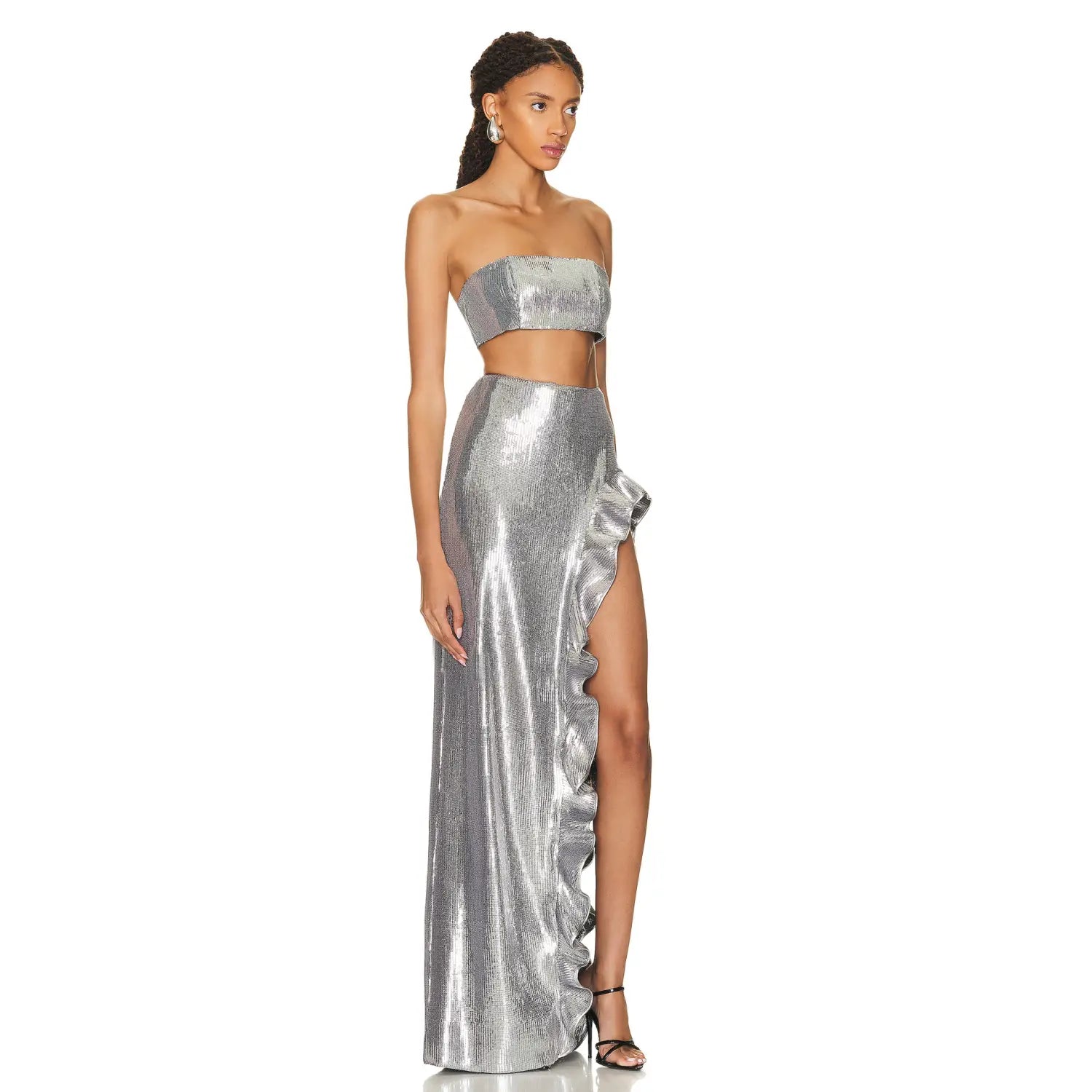 silver strapless sequin skirt set featuring a shimmering silver metallic two-piece gown with a strapless crop top and high-slit ruffled sequin skirt.