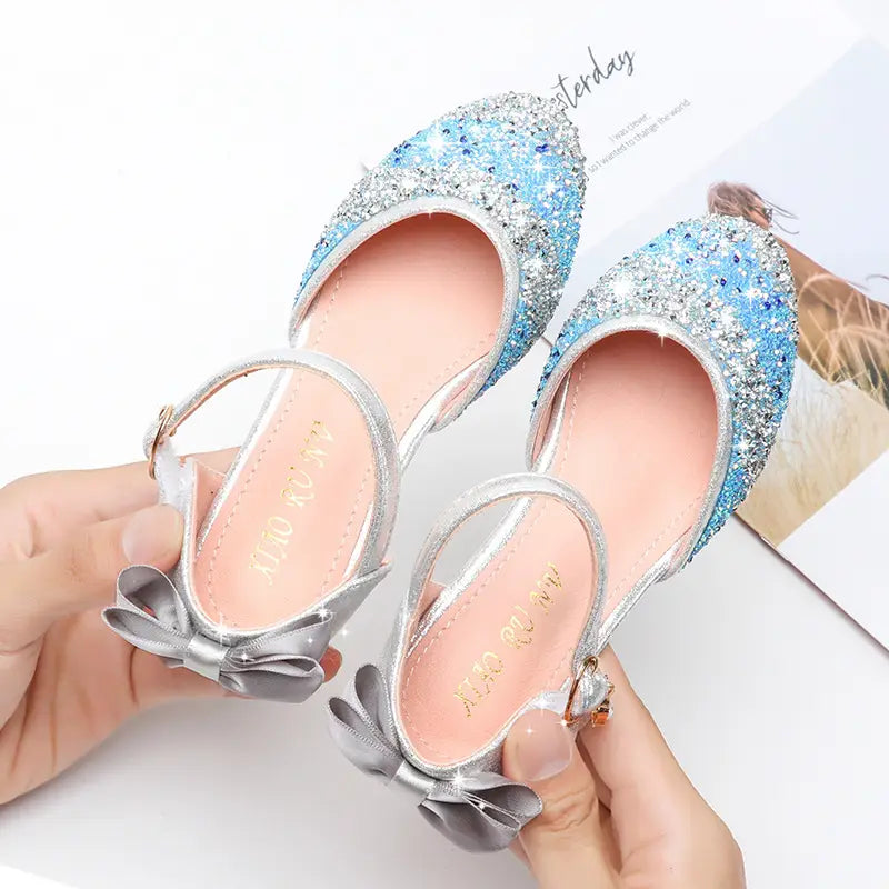 Blue and silver glittery girls high heel summer sandals with satin bows and sparkling rhinestone accents.