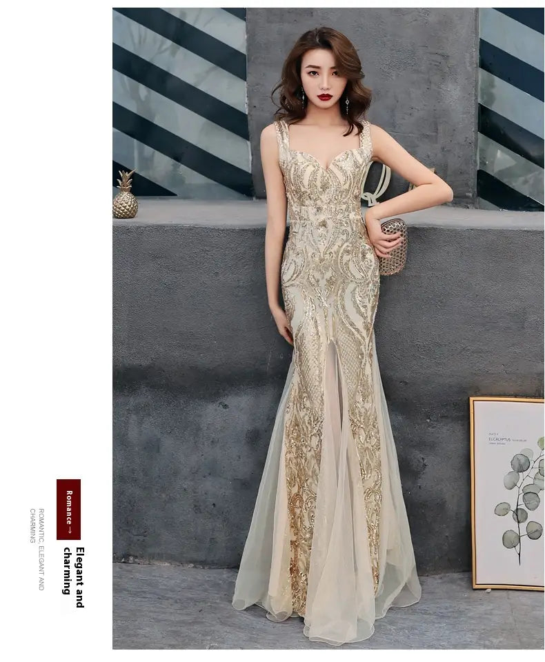 A shimmering gold-embellished black fishtail long summer evening dress with a fitted bodice and flowing skirt featuring long summer sequins sling details.