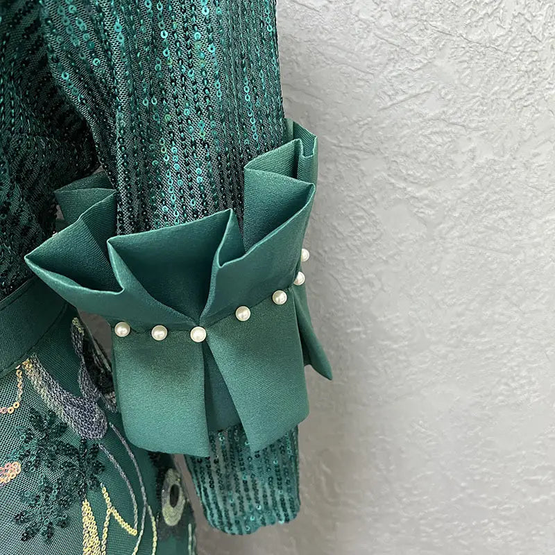 Emerald green satin ruffle cuff adorned with a row of small white pearls on a round neck half sleeve slim fit floral evening dress.