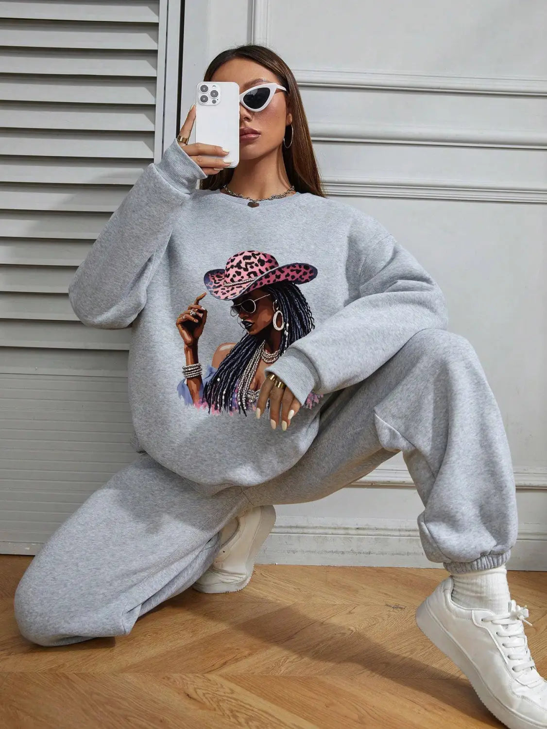 Gray oversized long sleeve sweatshirt featuring a vibrant graphic of a woman wearing a leopard-print hat and sunglasses.