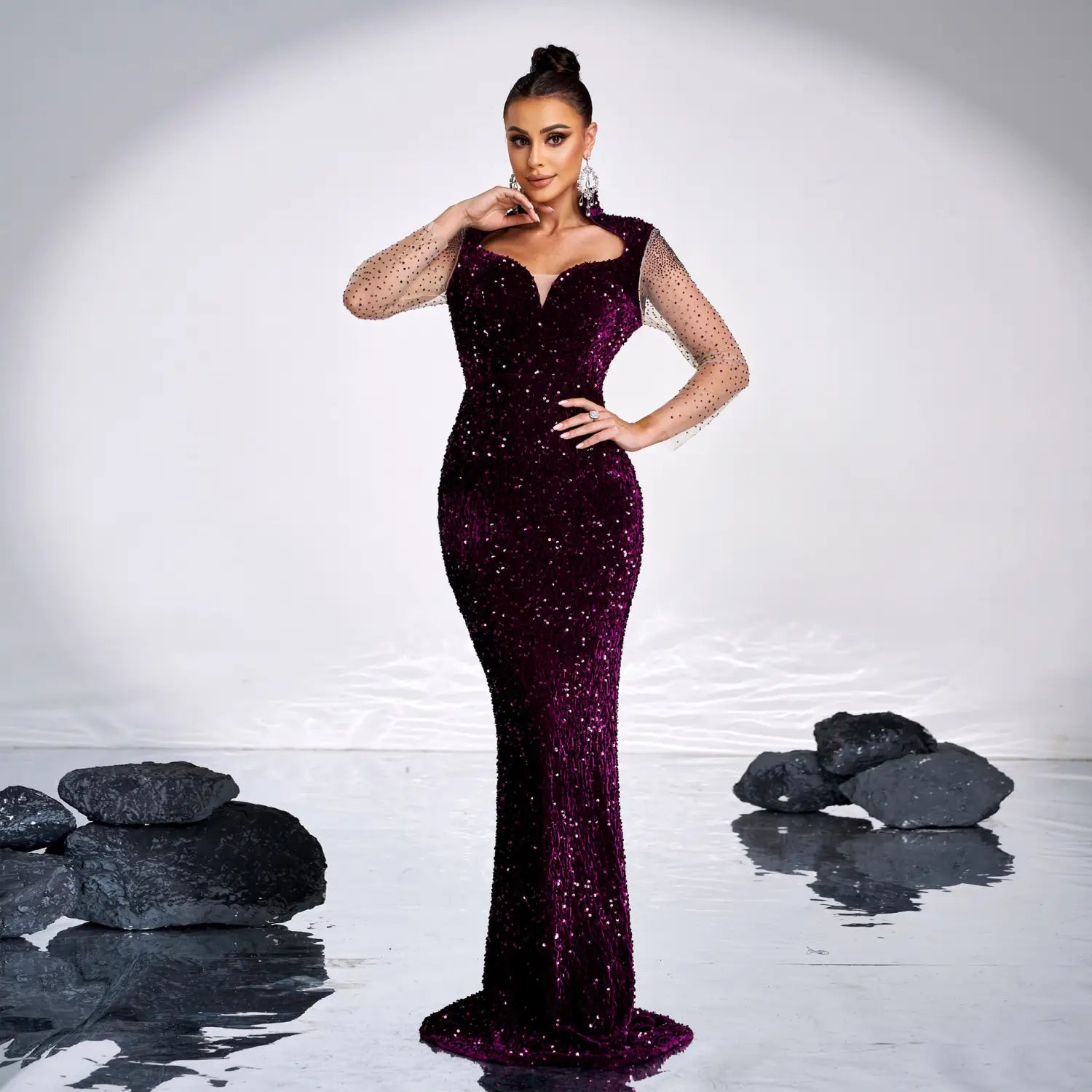 A shimmering deep purple sequined rhinestone fishtail gown with long sleeve sheer mesh detailing ideal for banquet occasions.