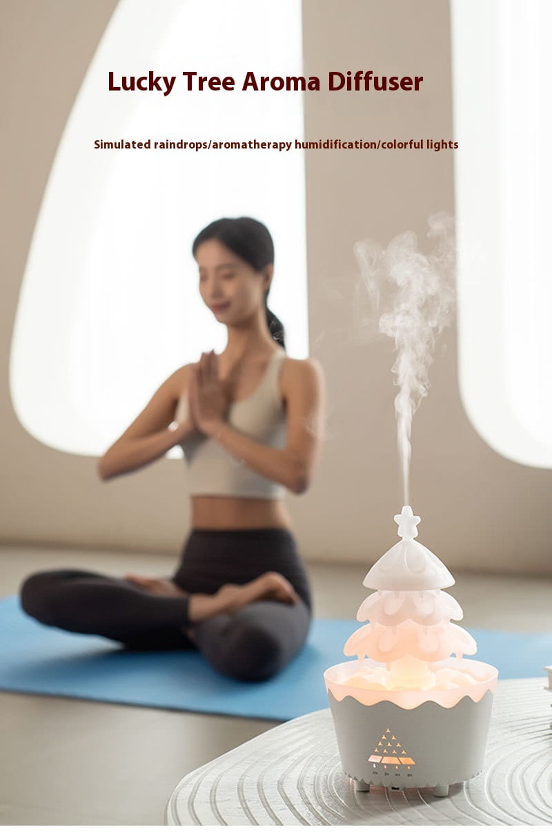 white tree-shaped christmas tree essential oil aroma diffuser humidifier with a soft glowing base and mist rising from the top designed for oil aroma diffuser use