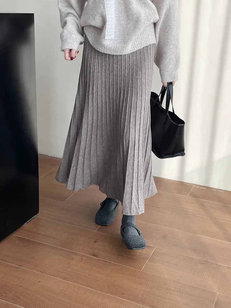 a soft textured gray pleated midi skirt with a subtle ribbed knit pattern featuring a korean elastic waist knitted design