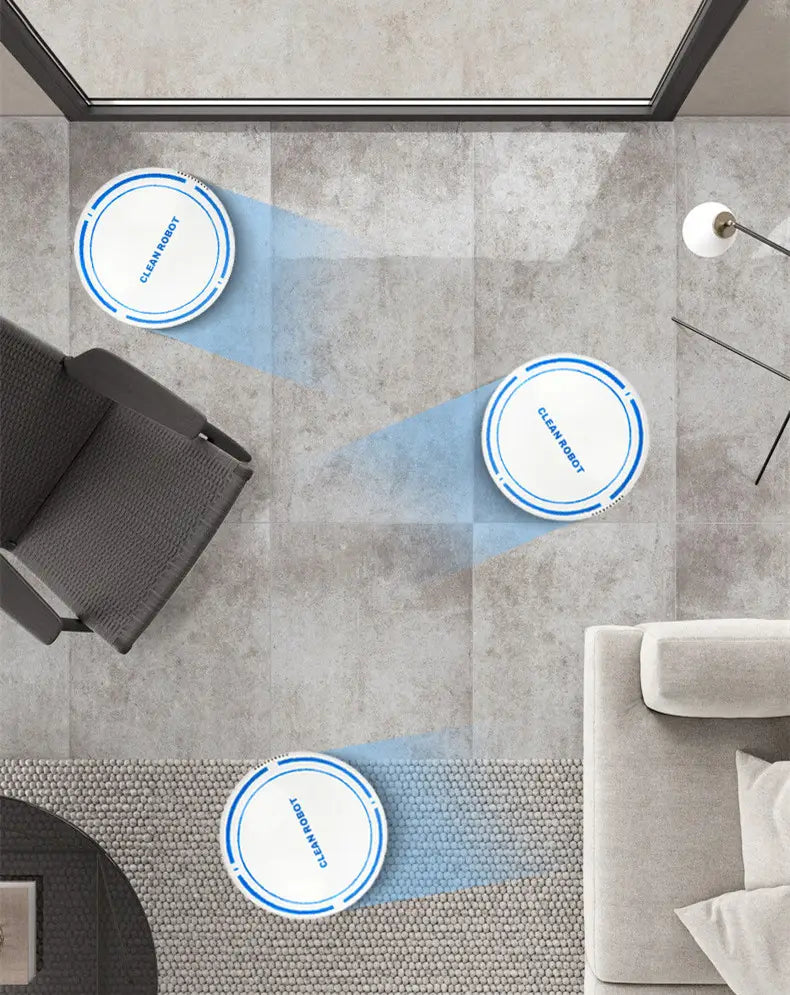 three white and blue circular mini desktop robot vacuum cleaners with clean robot printed on their tops positioned across a tiled floor for desktop cleaning use