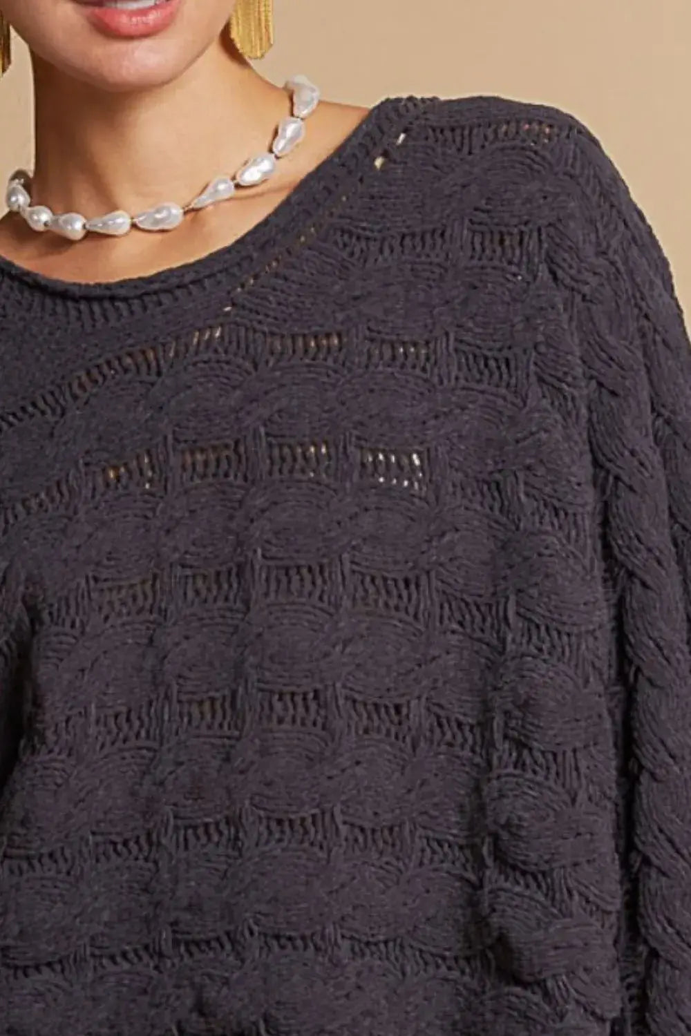 dark gray knitted pol round neck cable knit cropped sweater with textured wave-like pattern and subtle shimmering details