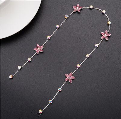 A delicate silver chain wedding hair accessory adorned with pink star-shaped charms and scattered pearls for elegant wedding hair styling.