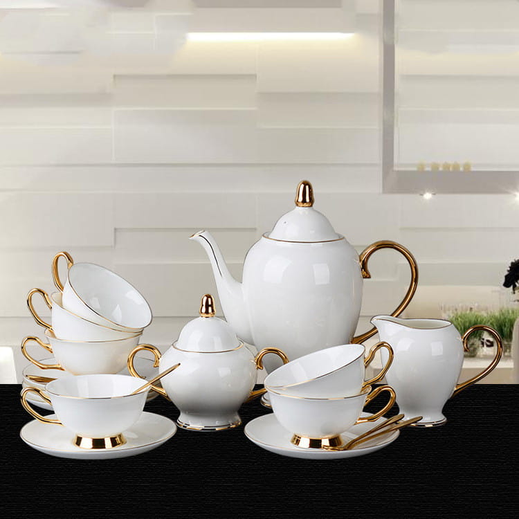 Elegant white bone china coffee cup and saucer afternoon tea set with gold-trimmed handles, spouts, and rims.