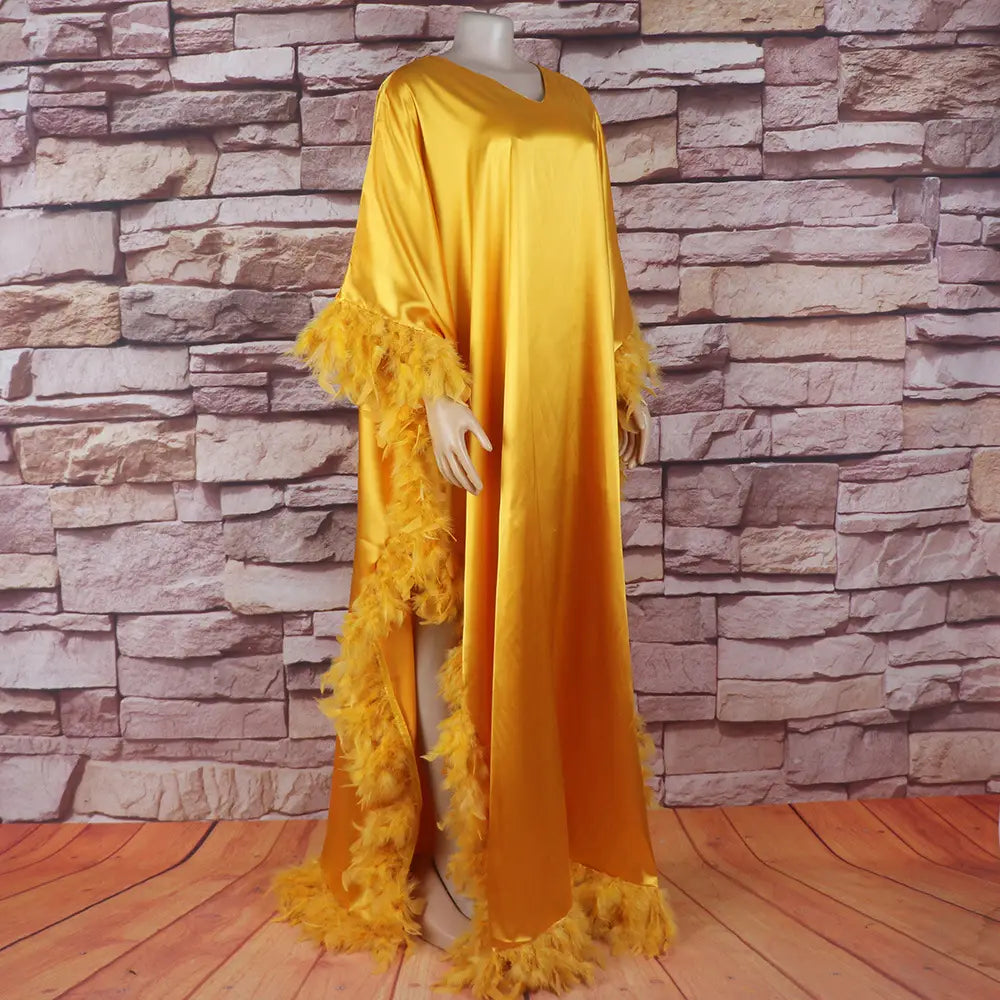 golden satin orange feathered loose dress luxury robe featuring vibrant yellow feather trim along the sleeves and hem, embodying a dress luxury fully style.