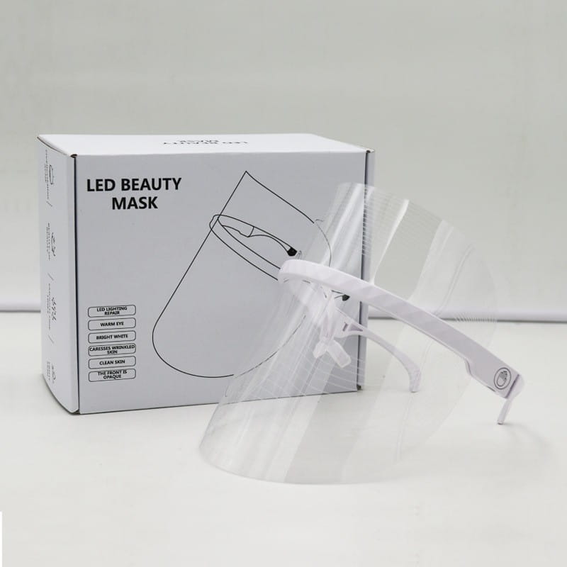Clear plastic face shield with a white adjustable headband designed as a multifunctional facial massager LED beauty mask for facial beauty and lifting tool massagers.