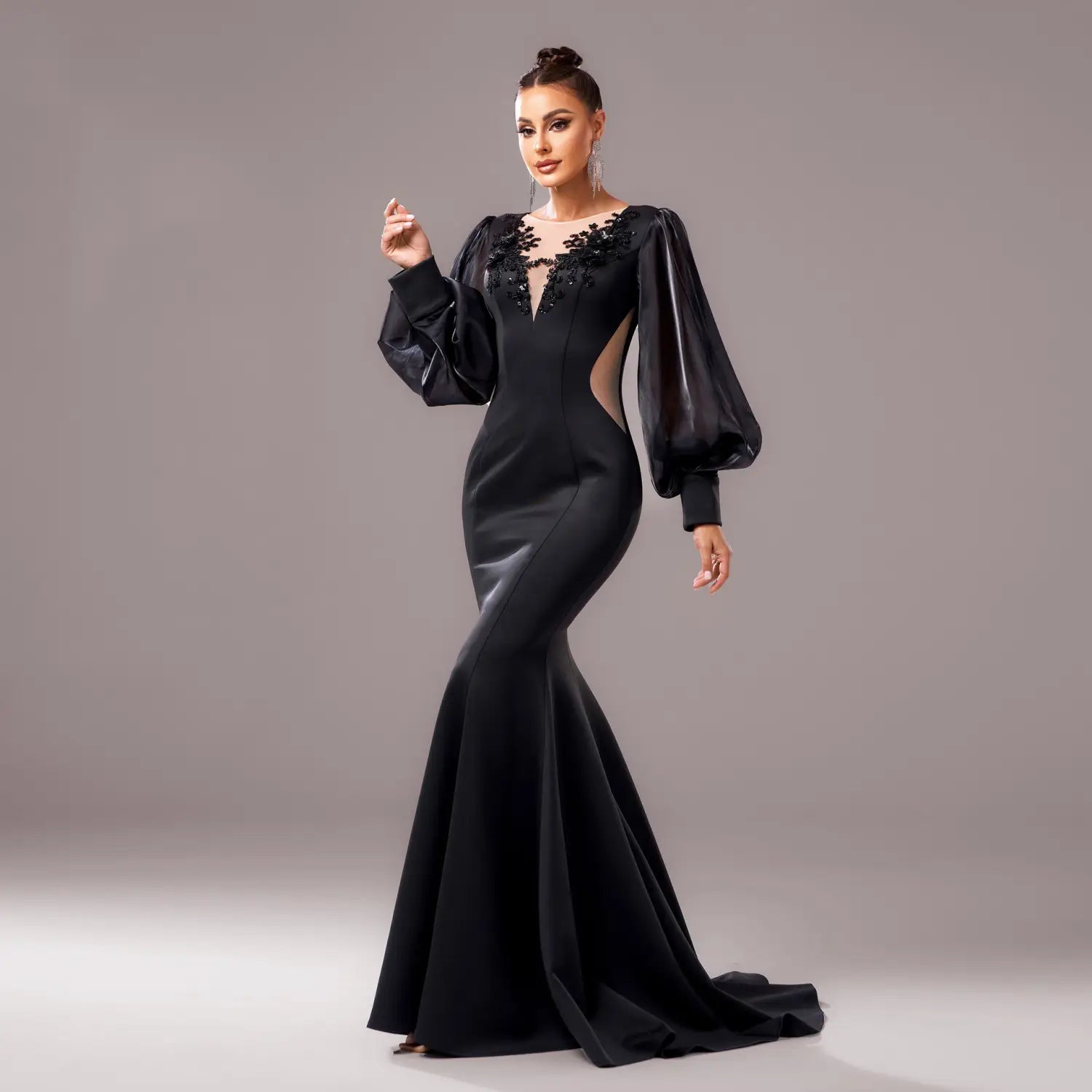 Elegant black satin mermaid fishtail gown with long sleeve round neck featuring sheer lace detailing and voluminous puff sleeves.