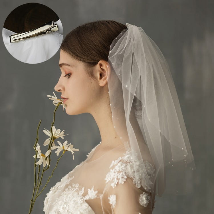 A retro short wedding lace floral veil in white tulle adorned with subtle pearl-like embellishments and a sleek silver metal clasp for secure attachment, ideal as a wedding bride headdress.