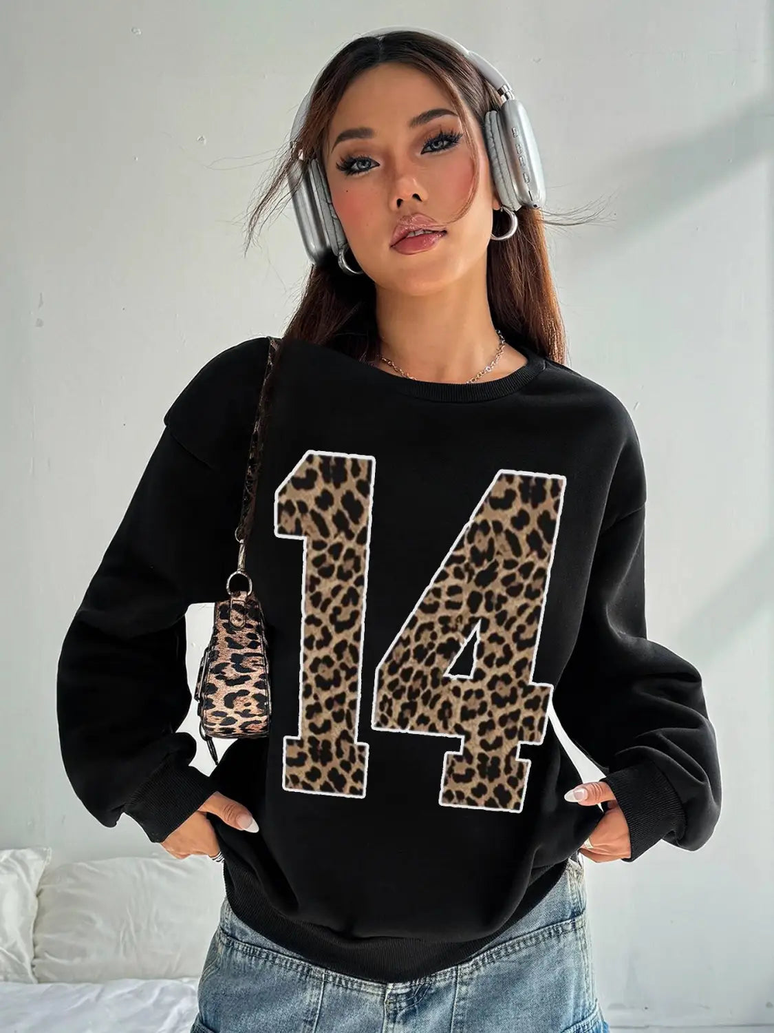 Black crew neck sweatshirt featuring a bold leopard print number 14 appliquéd across the front.