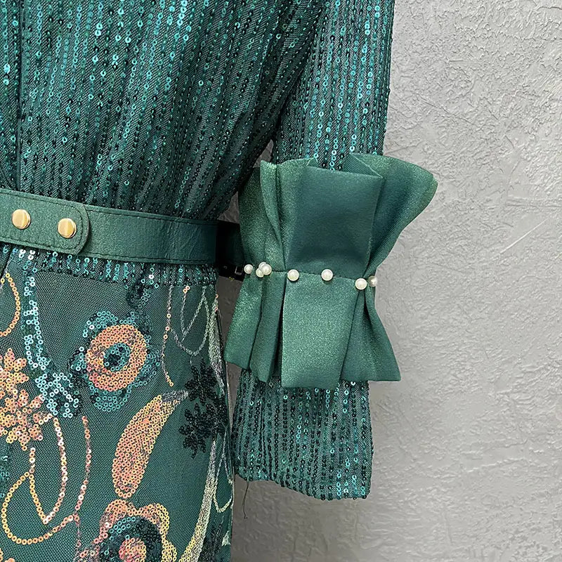 Emerald green half sleeve slim fit floral evening dress with round neck shirt style, sequined fabric, and satin bow cuff adorned with pearls.
