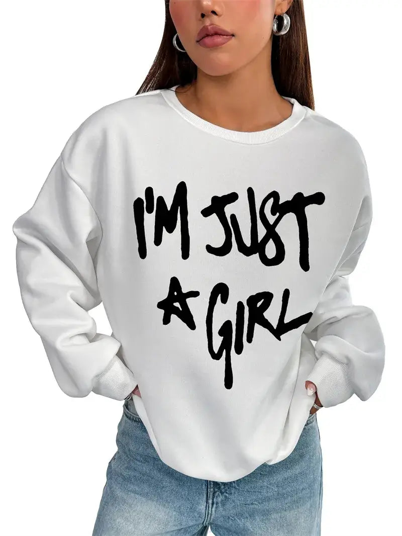 white oversized sweatshirt with bold black i m just a girl girl print round graphic in a casual handwritten font and round neck design