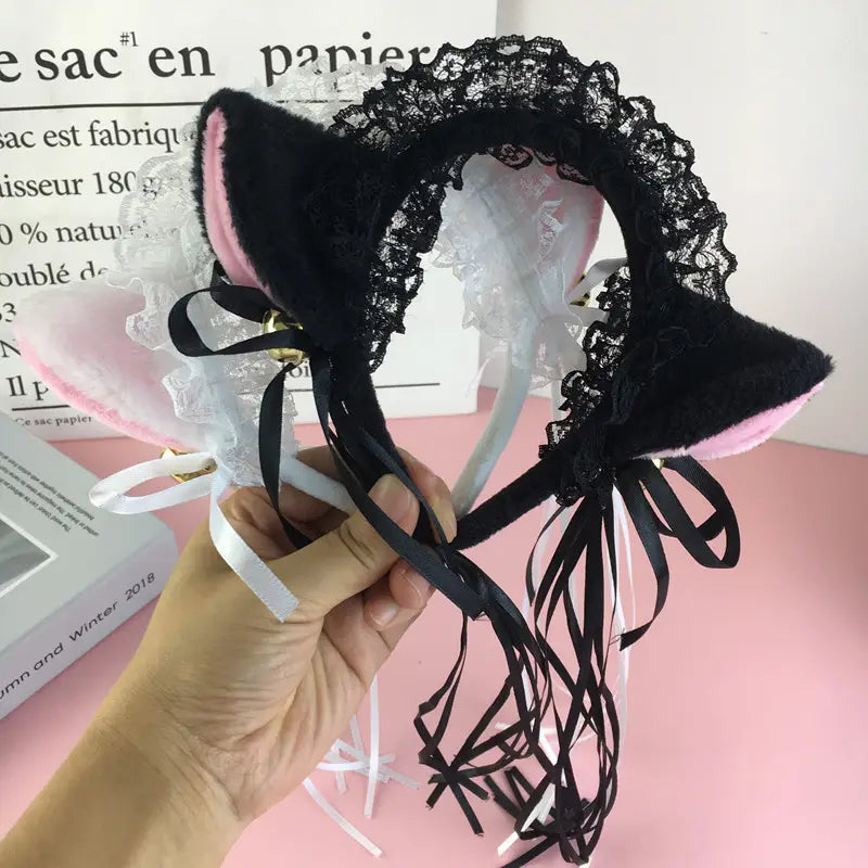 Japanese girl cute bells plush black and pink cat ear headband featuring lace trim and ribbon ties for a girl cute bells accessory.