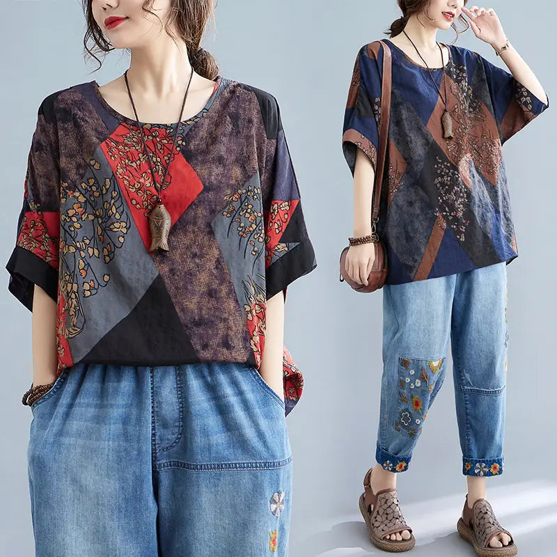 Stylish loose round neck printed patchwork blouse with a loose fit featuring bold geometric panels in deep blue red and earthy brown tones adorned with floral embroidery.