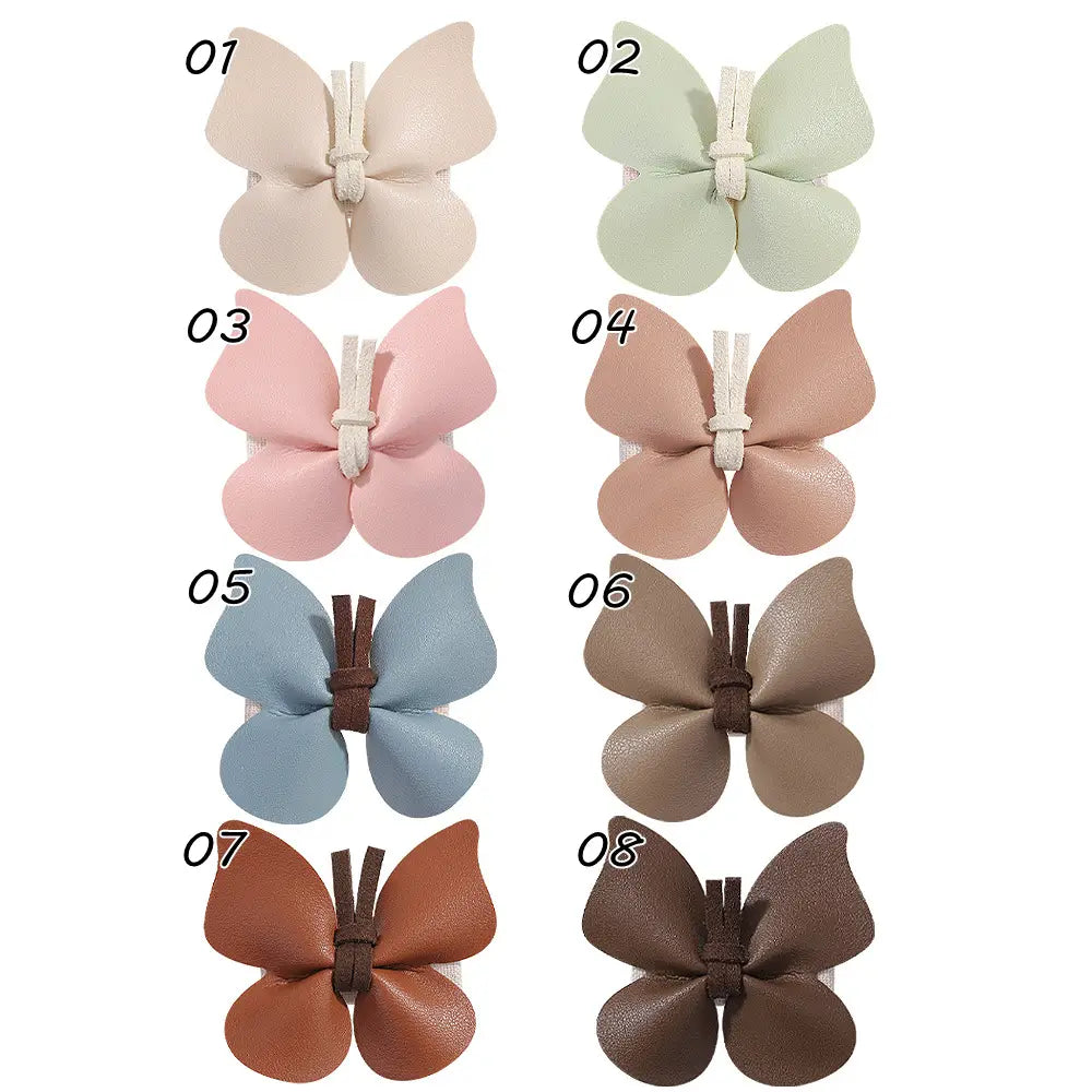 eight pastel and earth-toned leather butterfly bag clip children’s barrettes made of faux leather with a central tie closure