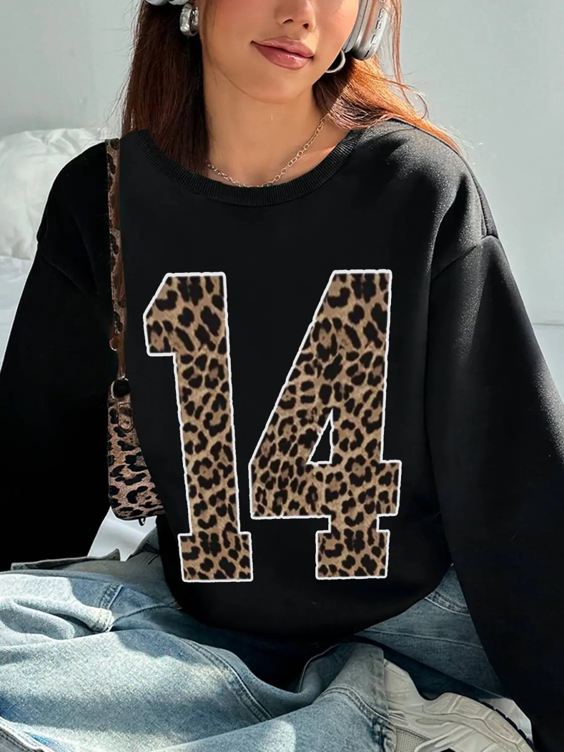 black crew neck sweatshirt featuring a bold leopard-print number 14 across the chest