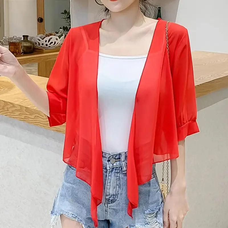 Vibrant red sheer chiffon cardigan with three-quarter sleeves and an asymmetrical hemline designed as a short shawl summer coat ideal for sun protection.