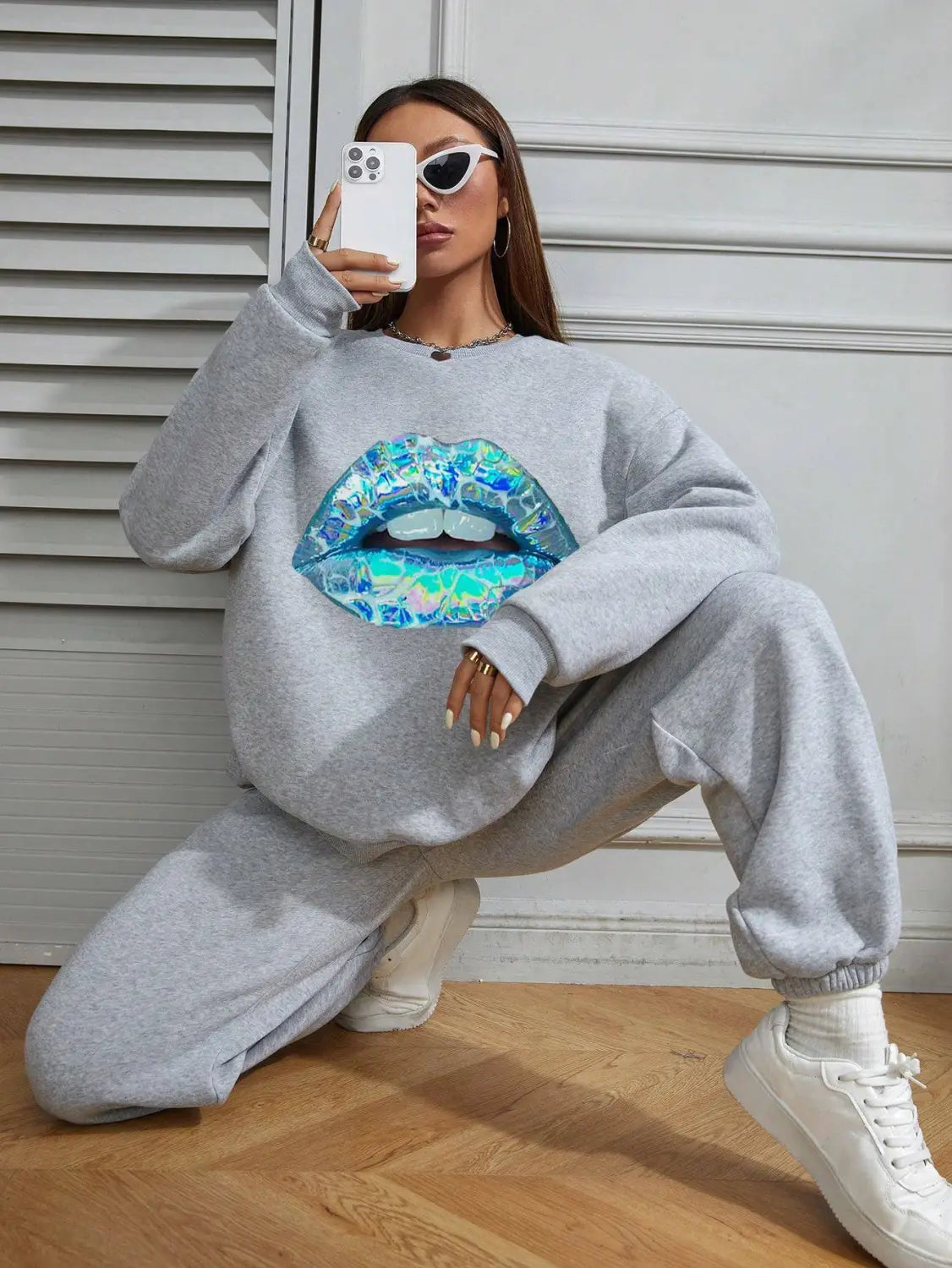 Gray oversized women’s crew neck long sleeve sweatshirt featuring a vibrant iridescent blue and teal lips graphic