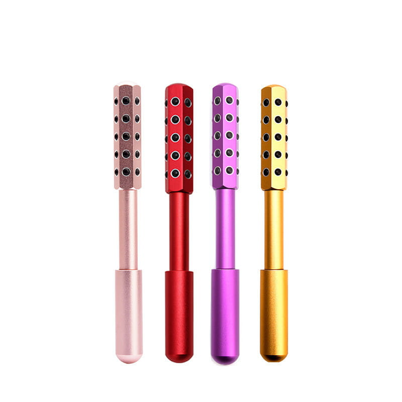 Four colorful metallic germanium beauty rollers with cylindrical handles and textured heads featuring evenly spaced circular indentations designed as massage sticks.