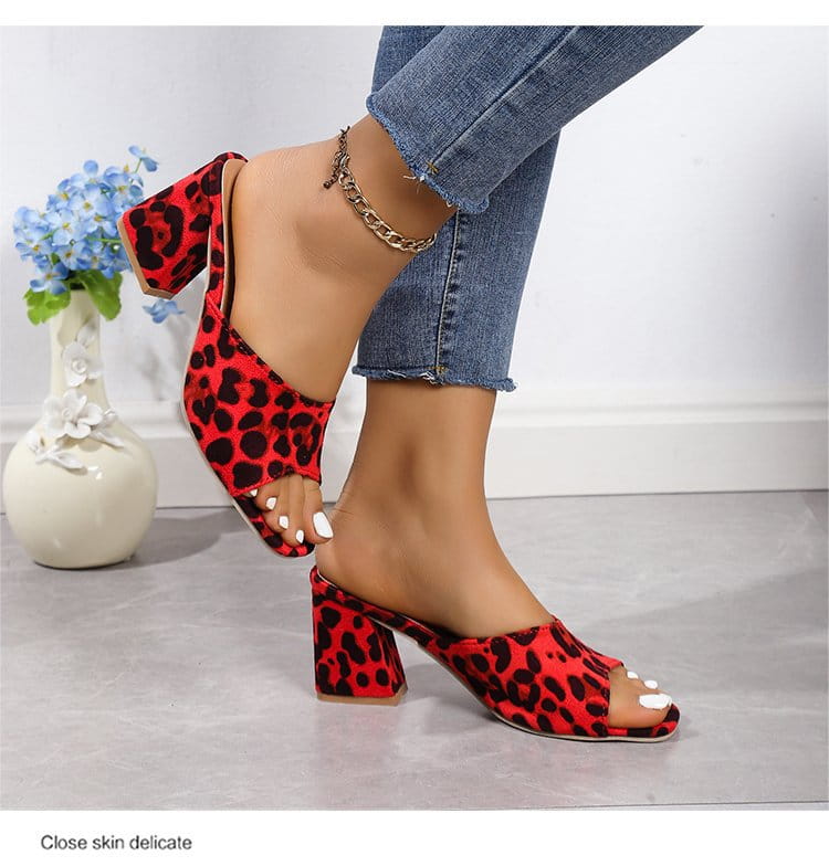red and black leopard square toe sandals with a block heel designed for summer use featuring a mule style and bold animal print pattern