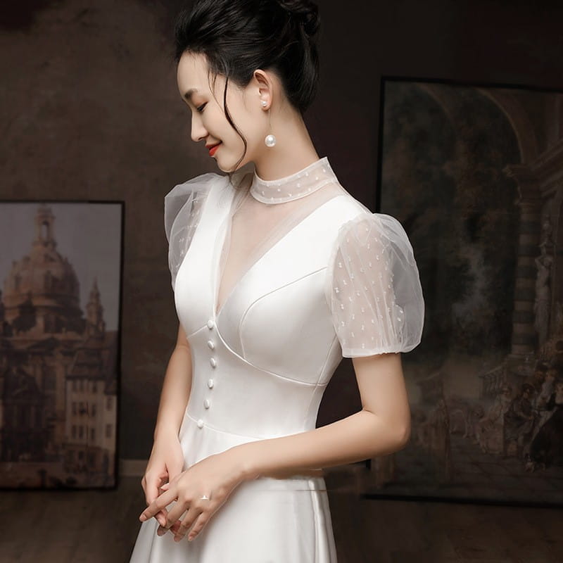 White satin puff sleeve engagement wedding dress featuring a high neckline, sheer mesh short puffy sleeves with subtle polka dots, and front button closure.