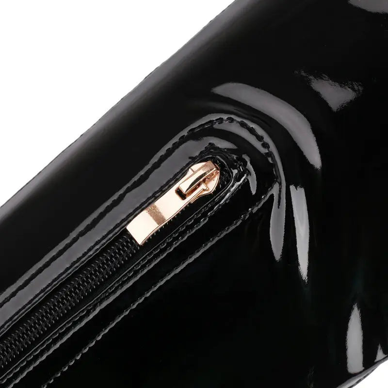 black patent leather clutch with rose gold zipper pull displayed alongside lace up peep toe patent leather female over the knee boots highlighting heel height and stylish design