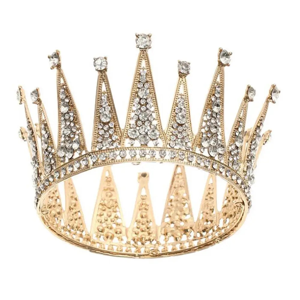 A sparkling gold alloy crown adorned with clear crystals and intricate filigree detailing designed as fashion bridal hair accessories and bridal hair accessories.