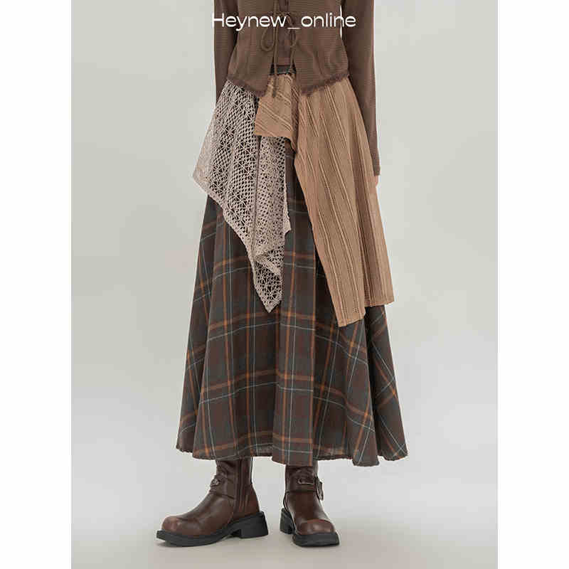 Brown plaid retro minority irregular a line skirt featuring layered earth toned fabric accents and a maxi length design.
