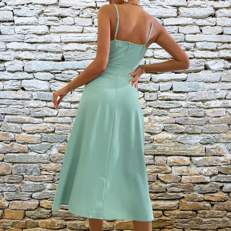 A mint green satin slit sling dress with thin spaghetti straps and a fitted silhouette perfect for sling dress summer fashion.