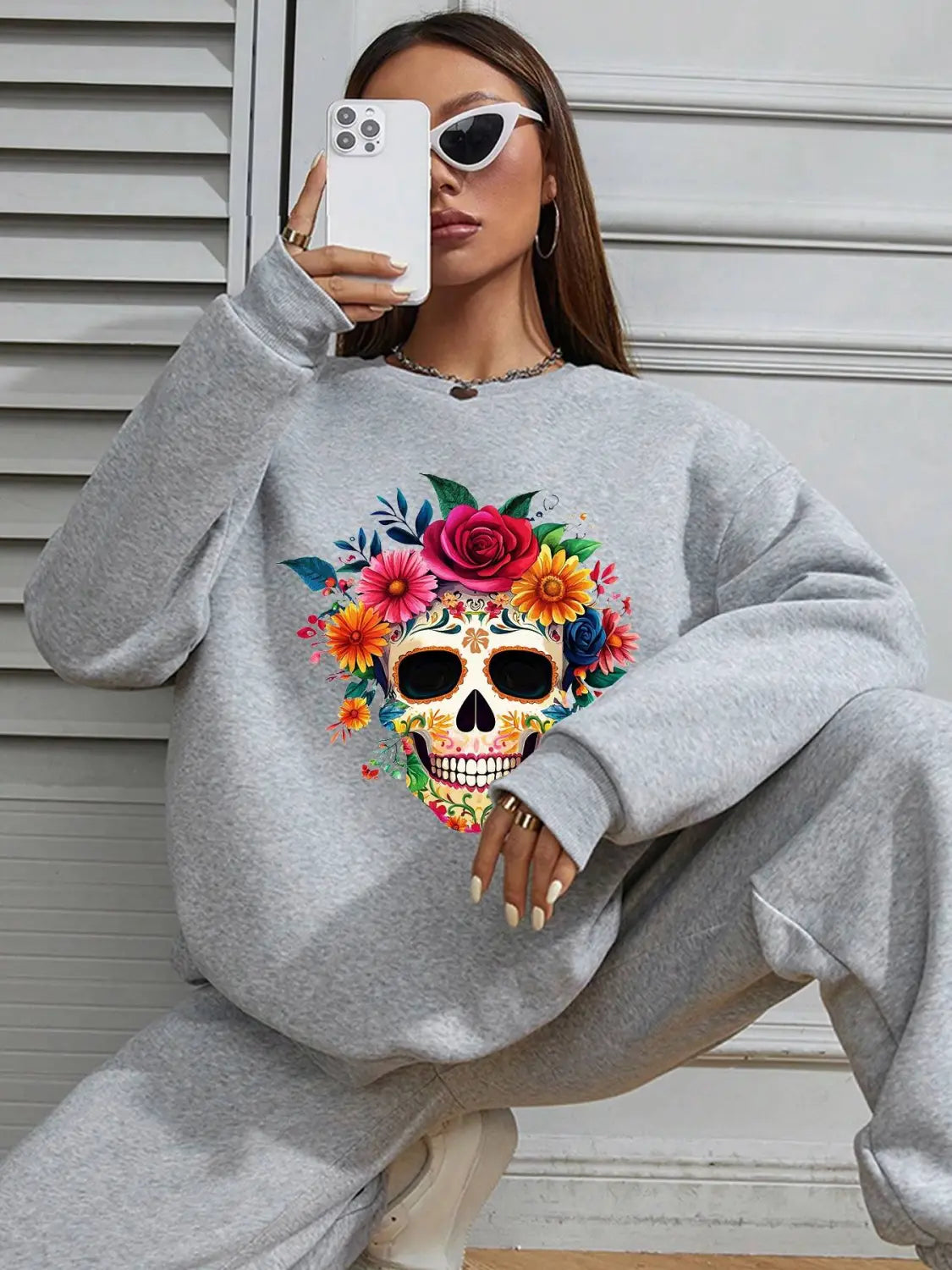 Gray crew neck sweatshirt featuring a vibrant colorful floral skull design suitable for daily wear basic long sleeve use.