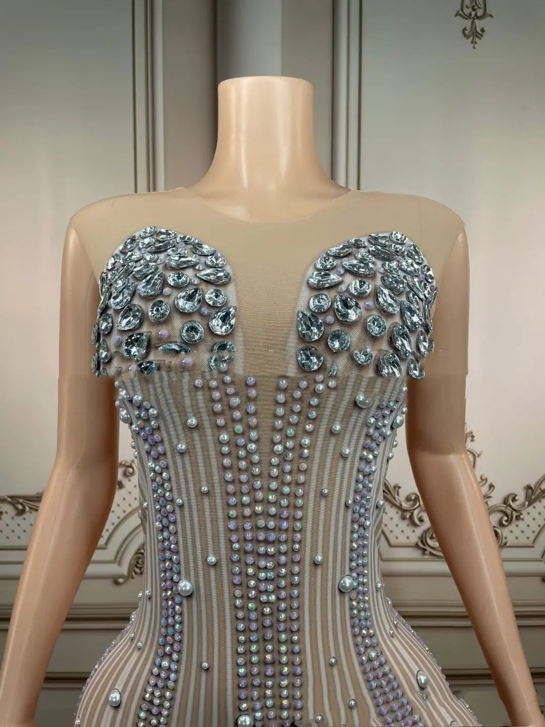 a shimmering silver beaded corset-style gown with intricate crystal embellishments and a sheer structured bodice designed as a hips nightclub bar sleeveless long gown