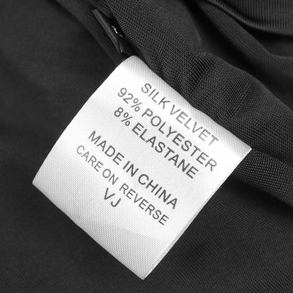 white fabric care label on the back side of a black camisole backless slim fit velvet floral gown detailing 92 percent silk velvet and 8 percent polyester elastane and marked made in china with a small vj logo