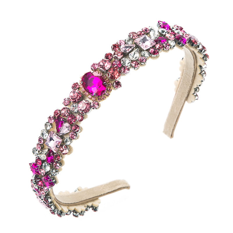 A sparkling pink and clear rhinestone baroque vintage court style headband with a soft beige velvet interior.