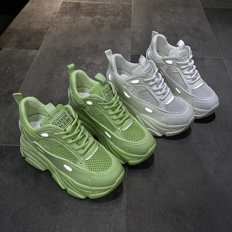 Pair of lime green and white casual sports single mesh shoes featuring chunky platform soles and reflective accents.