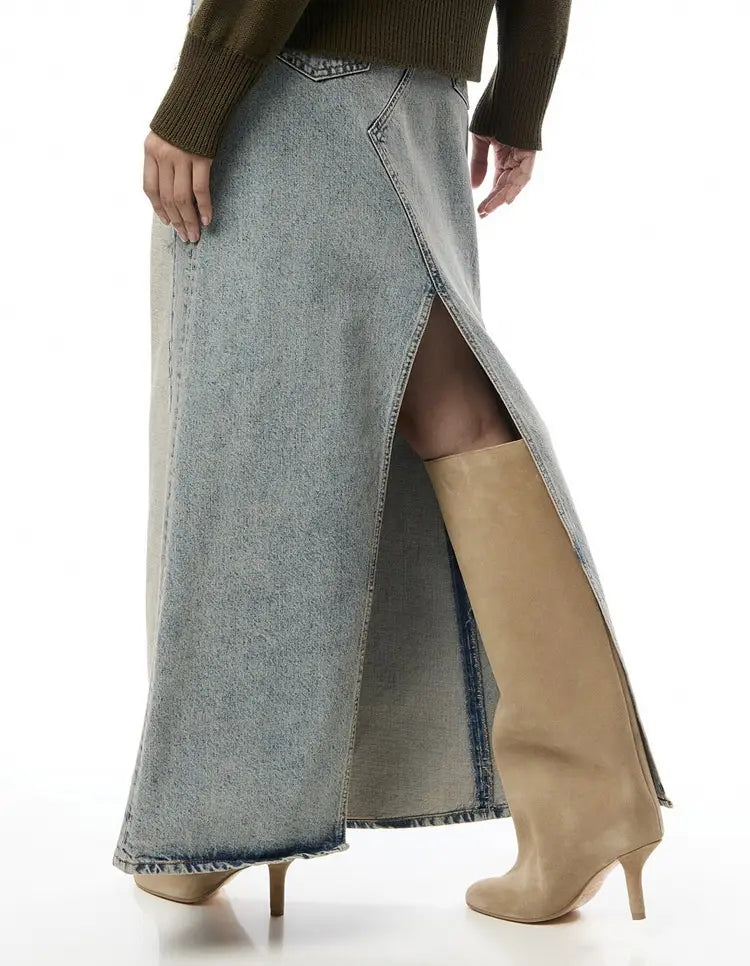 a light-wash denim maxi skirt with a high slit and flared hem paired with simple stitching square head black knee high boots made from yards custom materials