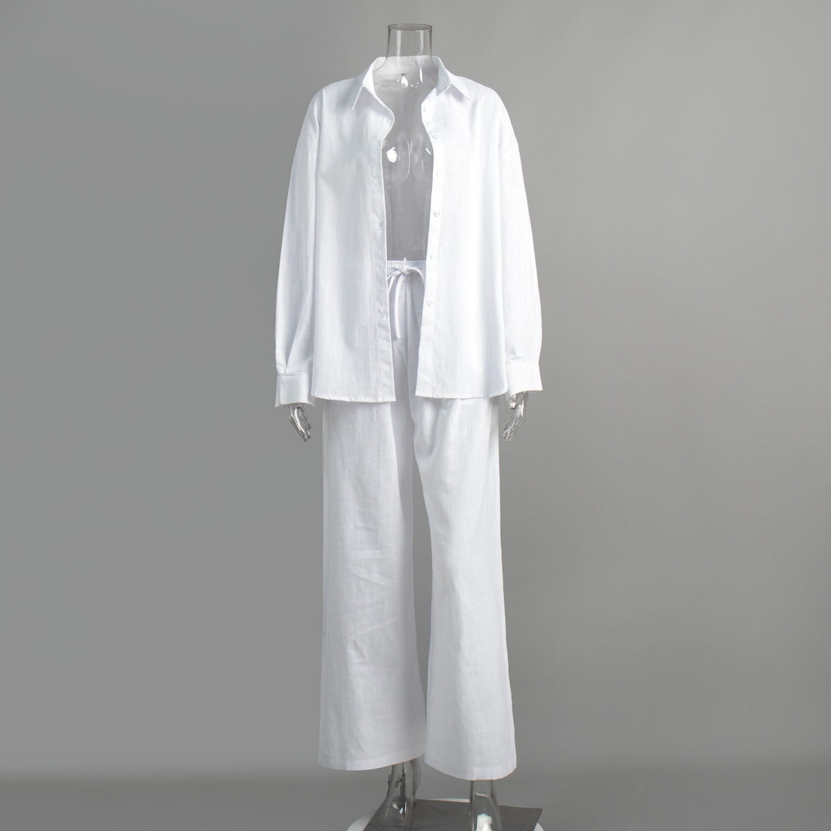 white linen long sleeve shirt trousers suit featuring an oversized button-up cotton shirt and matching wide-leg pants set in white color
