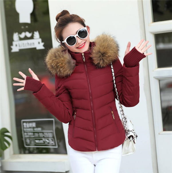 A maroon quilted parka jacket winter womens with a plush brown fur-lined hood and matching knit gloves designed for cold weather.