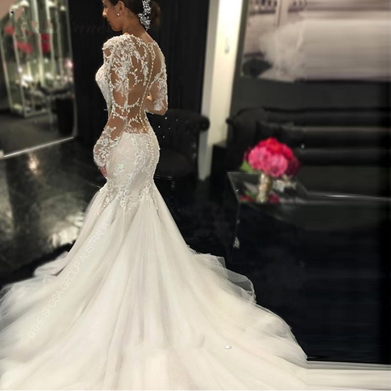 a trailing white temperament long lace wedding dress featuring a white mermaid-style silhouette with intricate lace detailing and long sheer sleeves made from polyester fiber