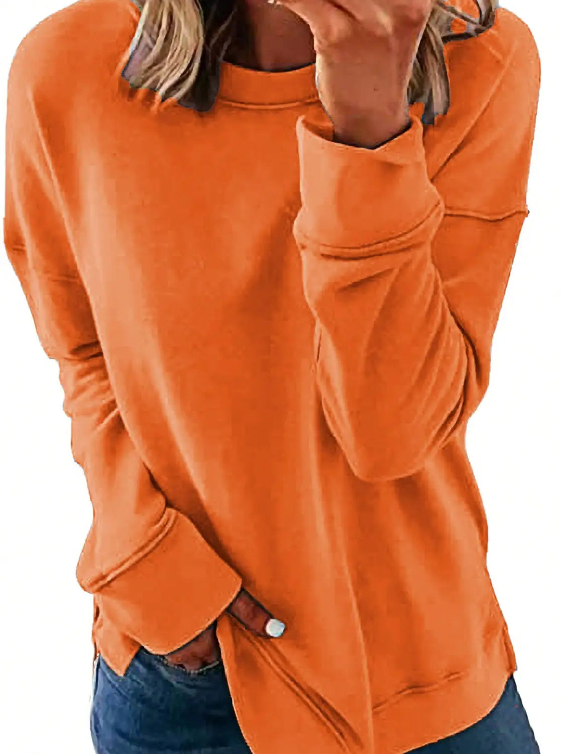 A cozy burnt orange long-sleeved sweatshirt with a relaxed fit and ribbed cuffs perfect for womens sweatshirts fall fashion.