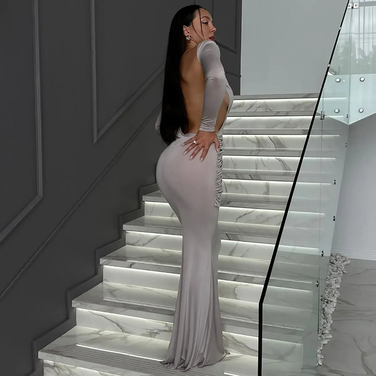 A sleek silver sexy hot girl long sleeve dress with a form-fitting design and back cutout detail.