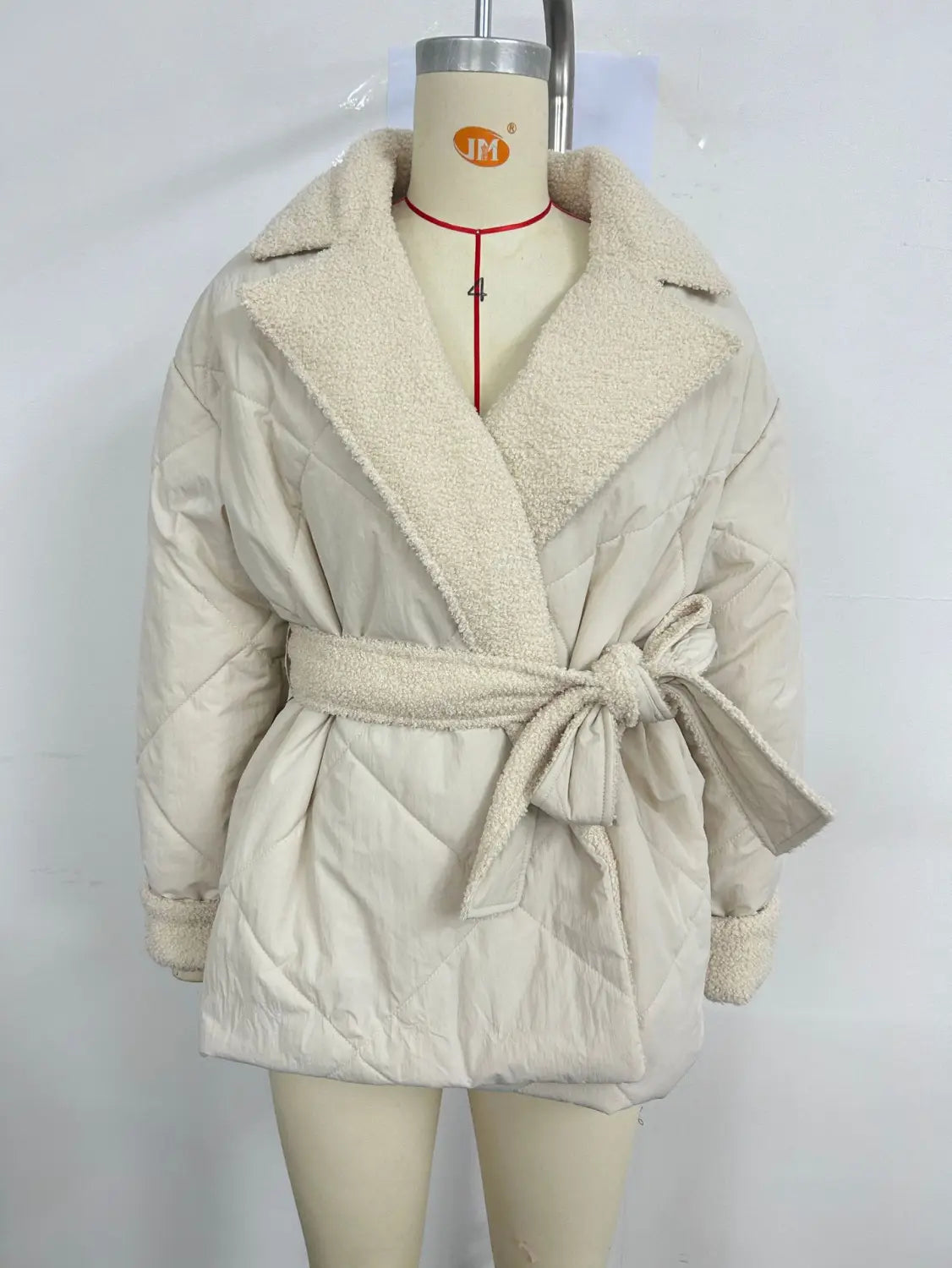 Beige winter lapel plaid coat featuring a cream-colored quilted design with a plush fleece-lined collar and matching belt for stylish plaid coat fashion.