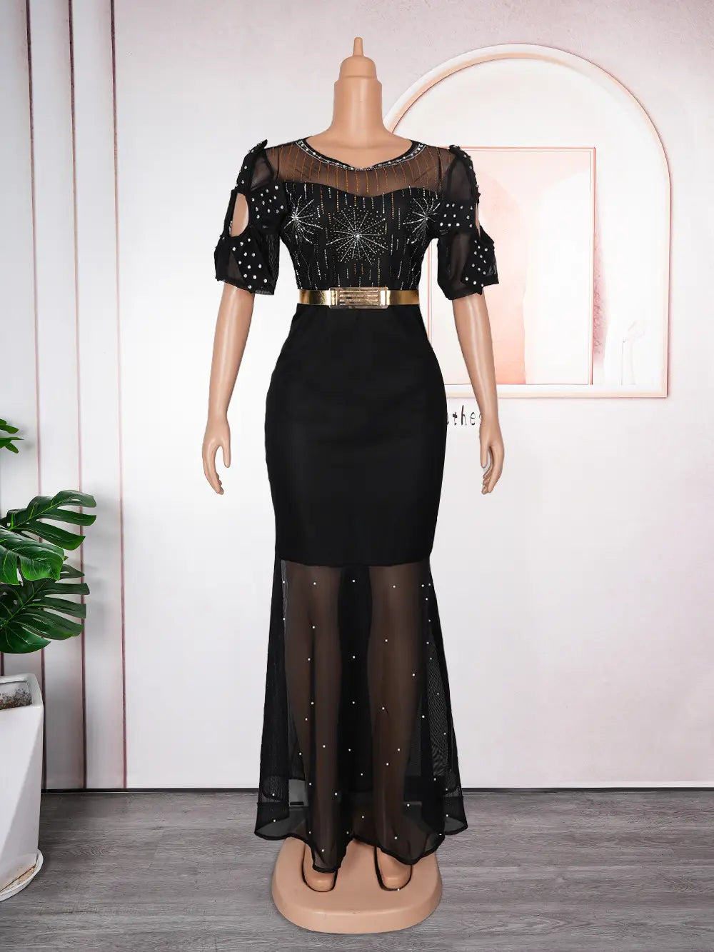 Black evening gown featuring a sheer, heavy embroidered hot diamond beaded bodice and skirt with a gold belt, ideal for formal occasions.