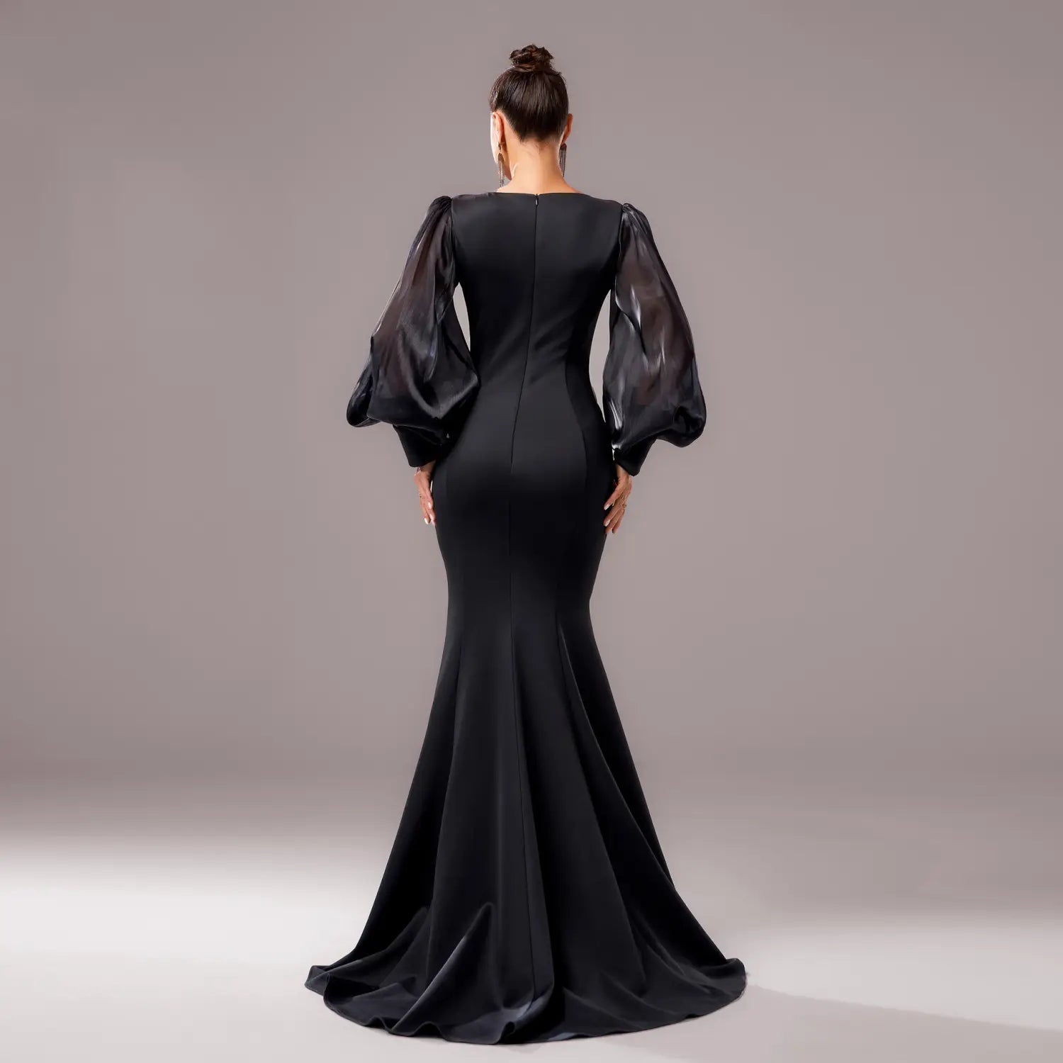 black long sleeve round neck fishtail gown with sheer voluminous puff sleeves and sleek satin finish